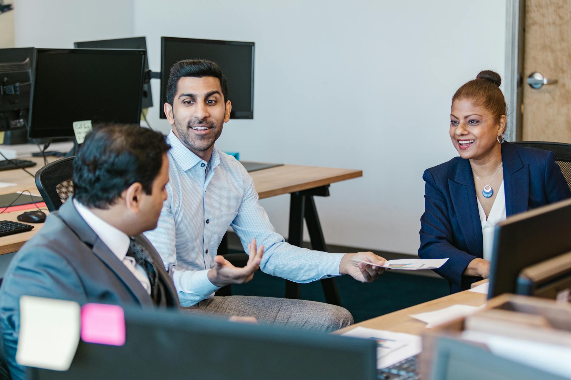 Professionals discussing a role in a modern office