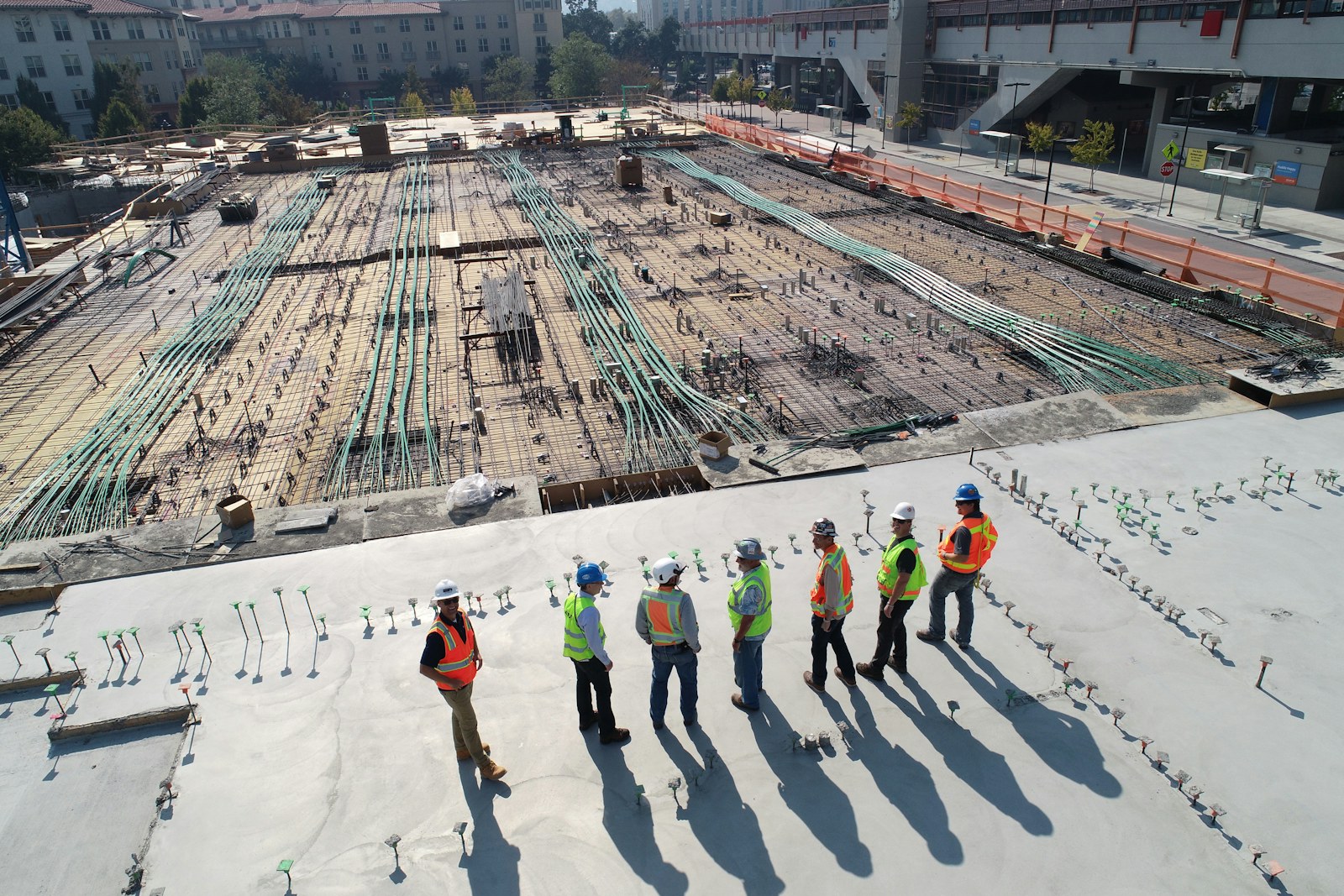 Construction workforce coordinating on an active project site